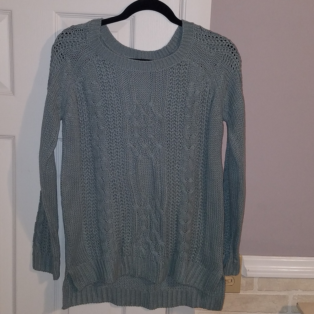 Light turquoise sweater.